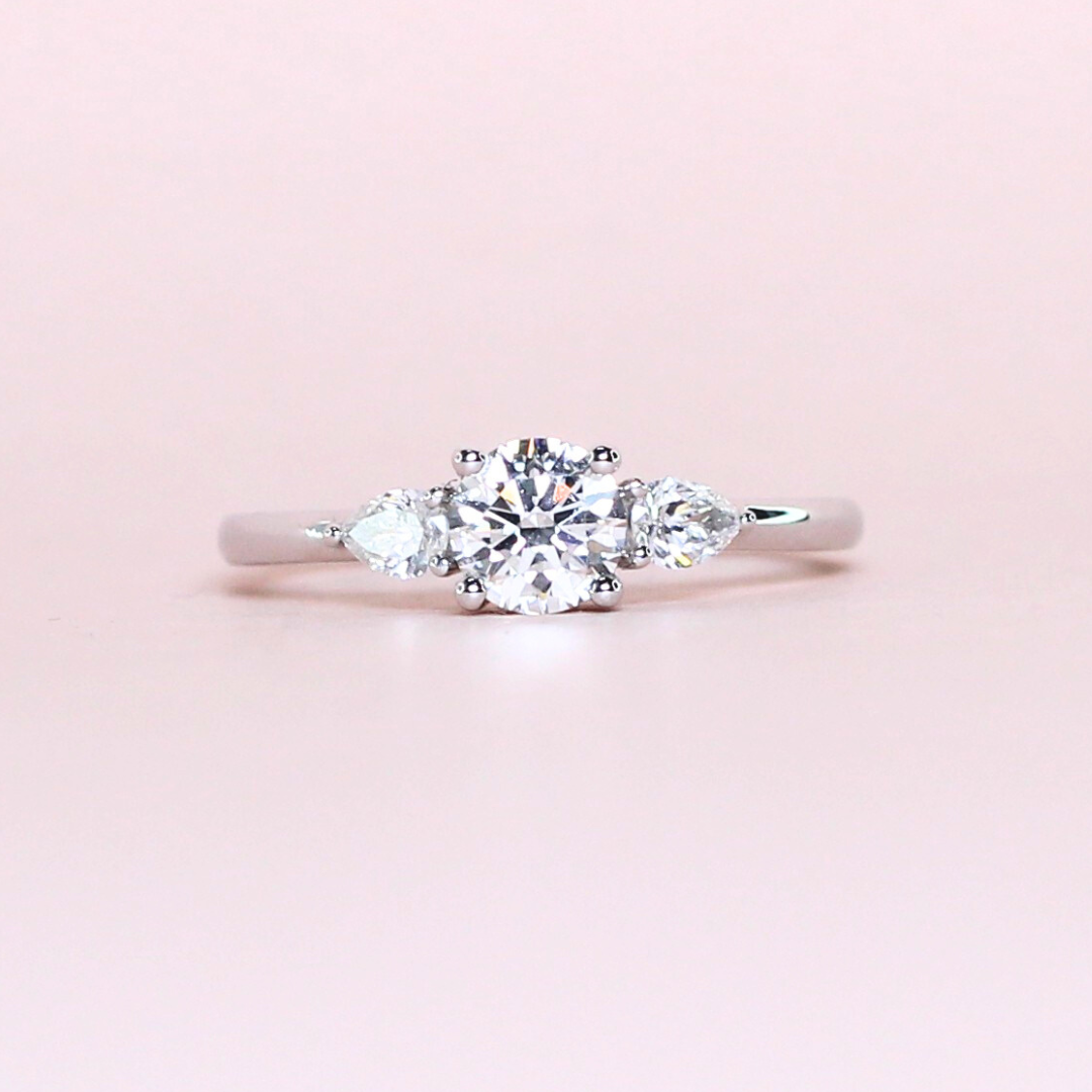 .52ct center; .20cts side Pear Stones