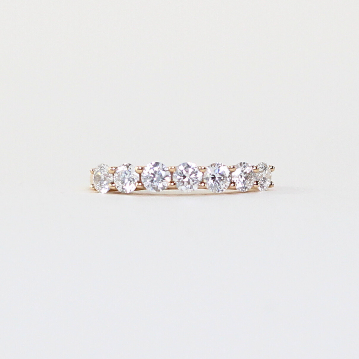 7-stone diamond ring in shared/wave prong setting